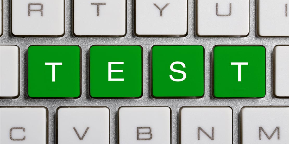 The image is zoomed in on a keyboard with a large blue button that has the word 