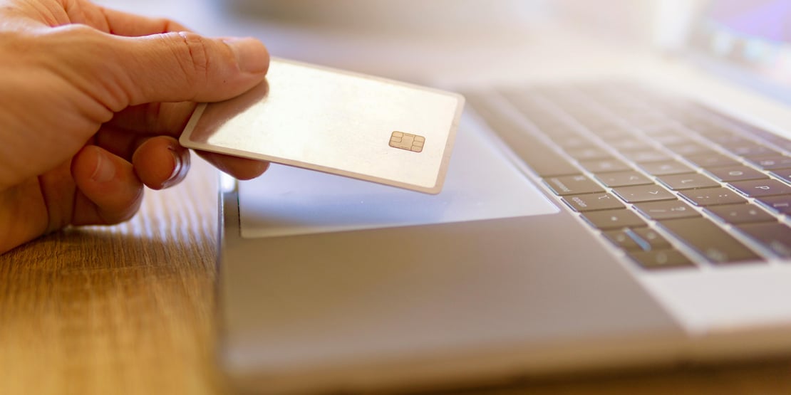 A person using a laptop to purchase something highlighting the importance of choice, consistent experiences, accessibility, and reliable payment infrastructure. 